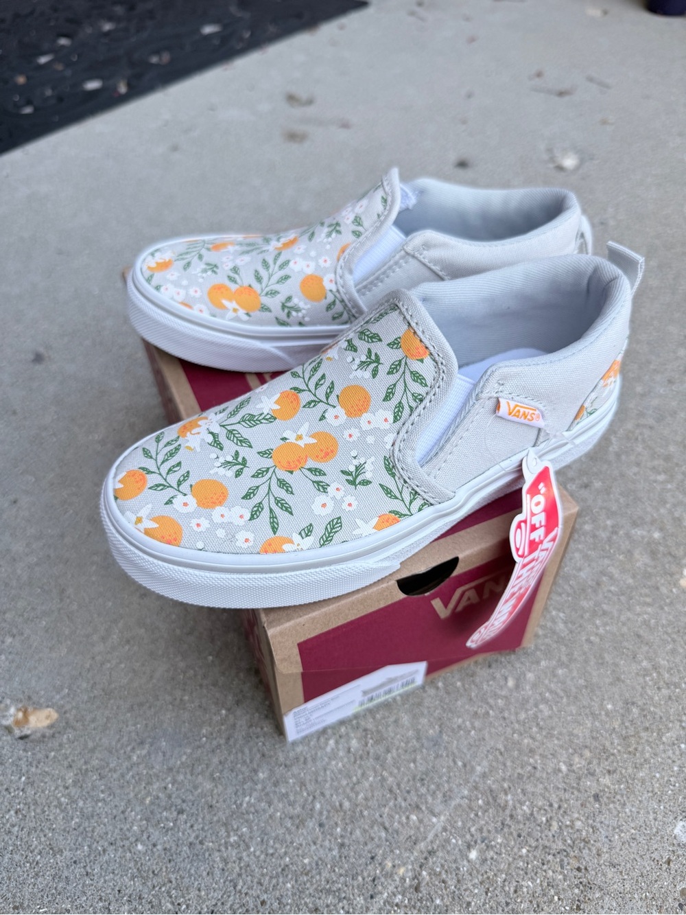 Vans Kids Slip-On Sneakers in White with Orange Floral Print